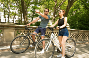 NYC activities - bike rental, two people on bikes taking a selfie